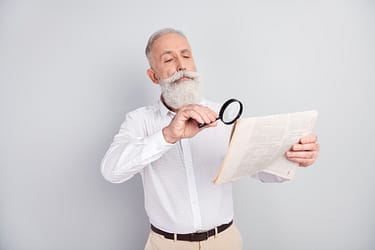 Photo of handsome strict grey hair old man teacher read magazine wear white shirt isolated on grey color background.
