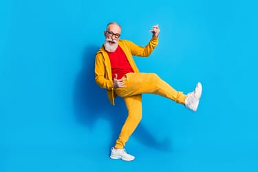 Full size photo of happy good mood excited funky grandfather playing invisible guitar isolated on blue color background.